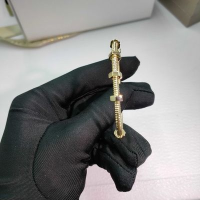 18K yellow gold (750/1000). Width: 3.5 mm Ecrou de Brand bracelet