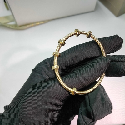 18K yellow gold (750/1000). Width: 3.5 mm Ecrou de Brand bracelet