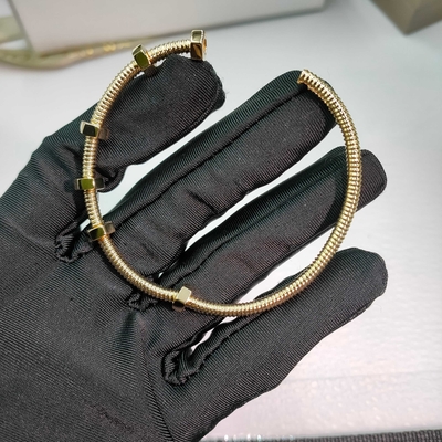 18K yellow gold (750/1000). Width: 3.5 mm Ecrou de Brand bracelet